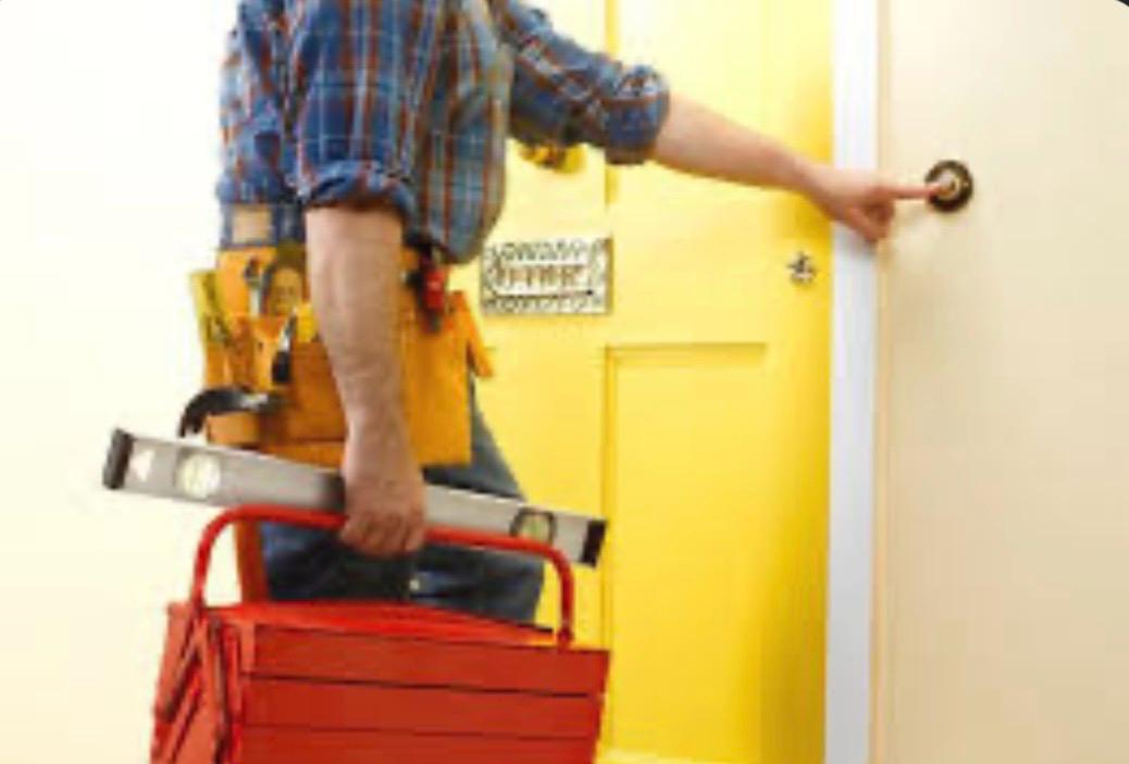 Handyman carrying a toolbox and spirit level for general property maintenance in the Fylde Coast